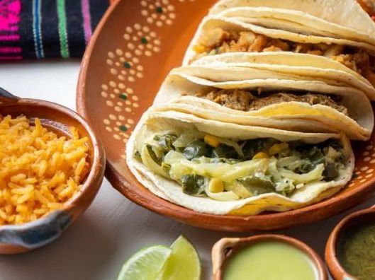 Tacos con guisado servidos sobre un plato de barro